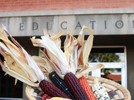 A basket of corn with the Education building in the background